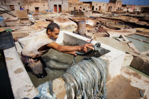 A tannery worker treating the leather in one of Marrakesh's tanneries.