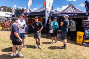 Visitors chatting under the Trash Free Trails tents at the Sea Otter expo