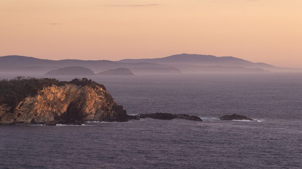 Rocky shoreline and calm bay water looking north near Batemans Bay